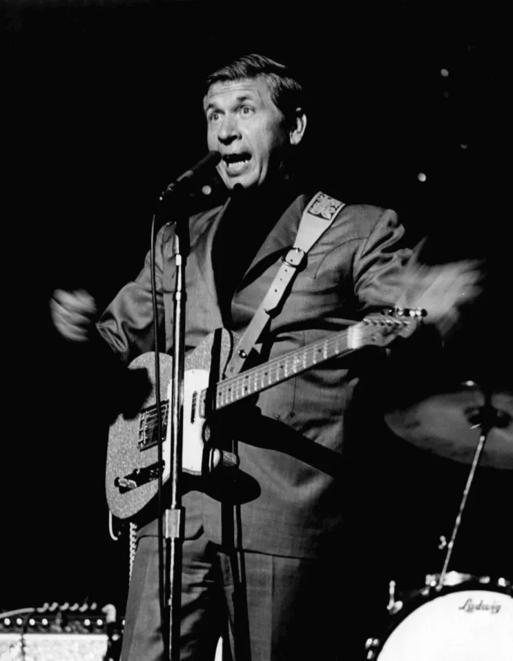 Buck Owens playing guitar on stage at the Washington State Fair, 1968