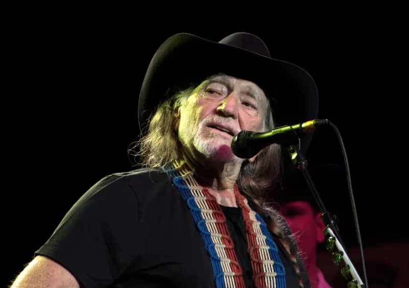 Willie Nelson singing on stage in 2009